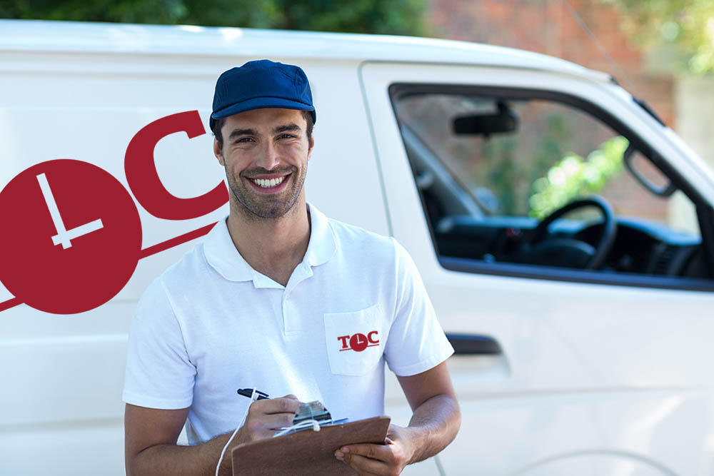 Portrait of happy delivery man with clipboard while standing by van Portrait of happy delivery man with clipboard while standing by van